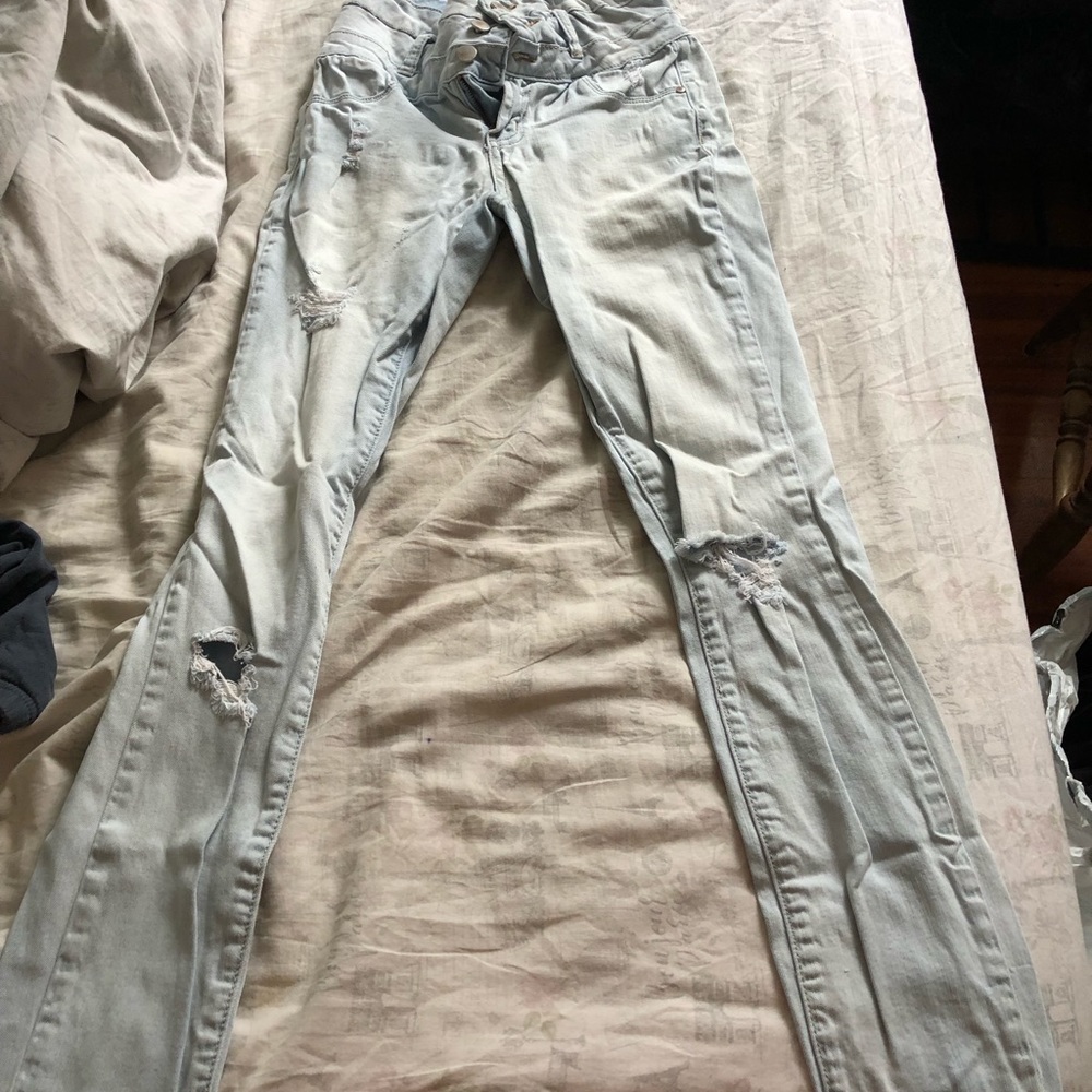 Light blue skinny jeans with a couple rips